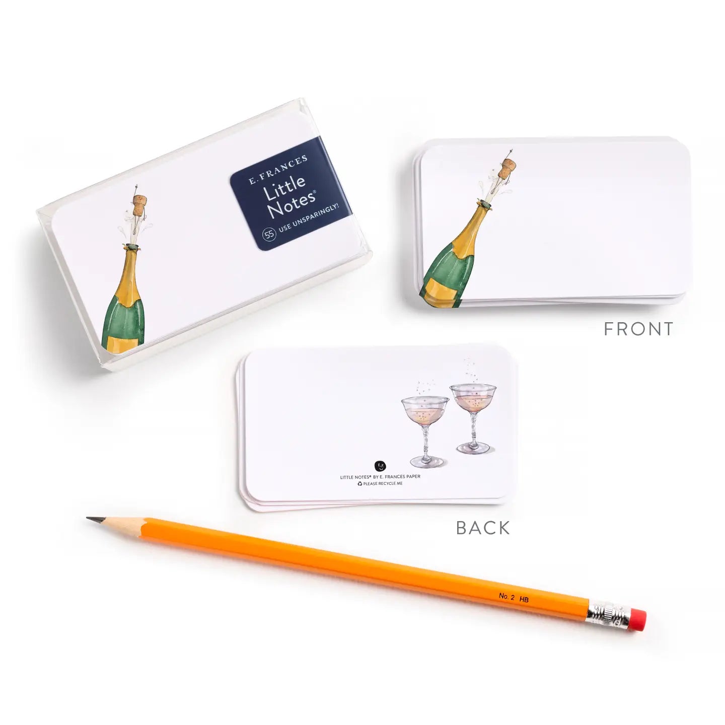 Notecards with champagne bottle and glass illustrations, accompanied by a pencil on a white background.