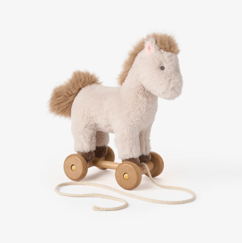 beige plush pony pull toy with a darker brown mane and tail and wooden wheels 