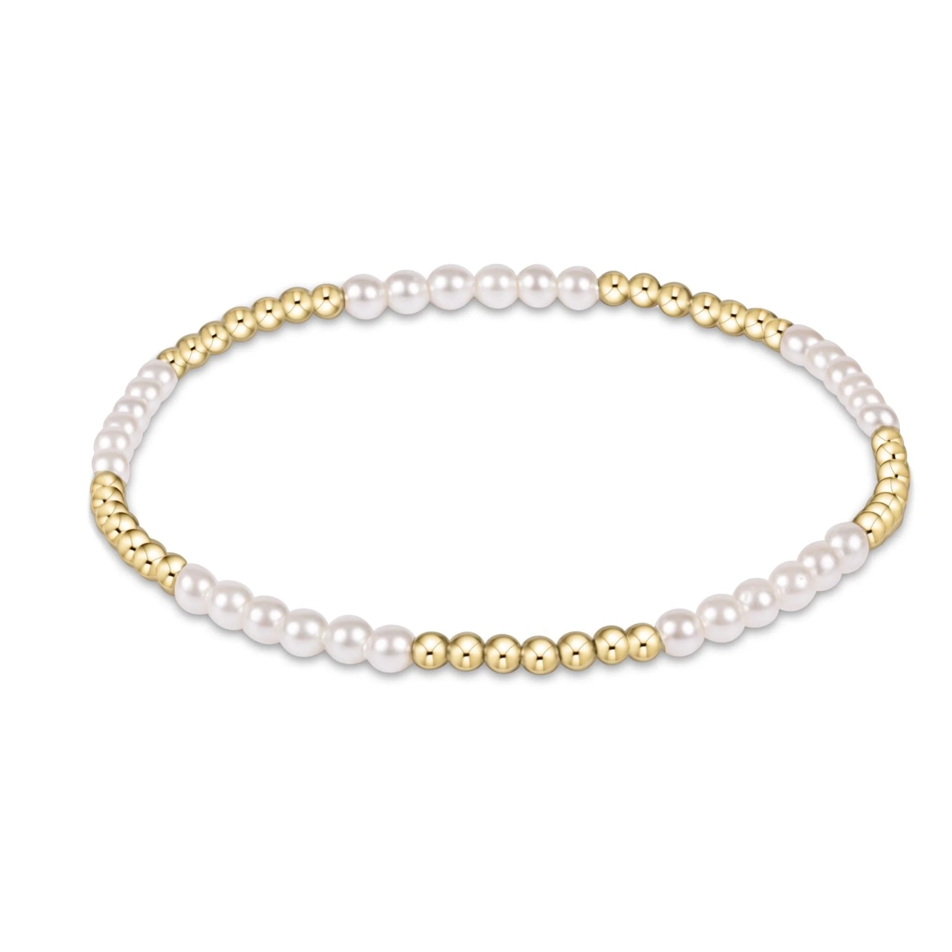 enewton blissful bracelet with several 3mm Pearl beads alternating with several and 2.5mm gold beadst on a white background