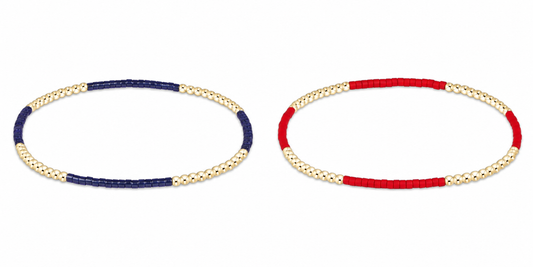 Two enewton gameday hope blissful beaded stretch bracelets on a white background, one with navy blue and gold beads and the other with red and gold beads.