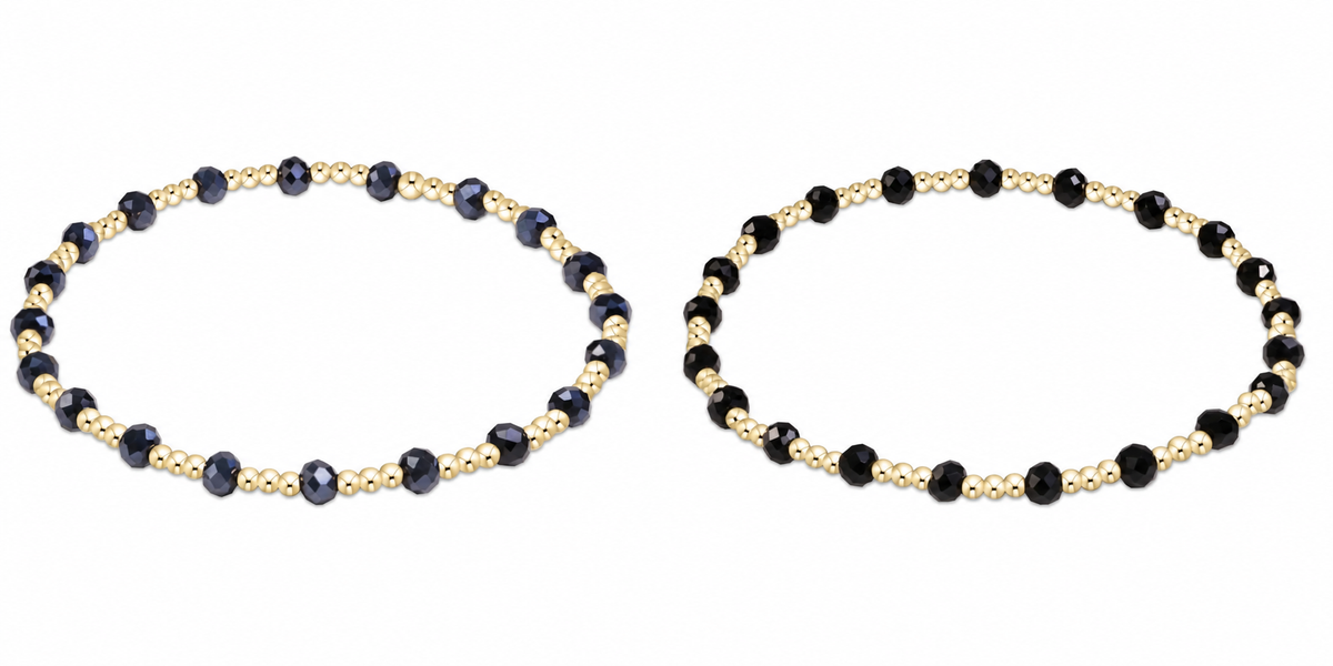 Two beaded enewton gameday serinity stretch bracelets on a plain white background. Each bracelet features alternating dark faceted beads and small metallic gold spacer beads.