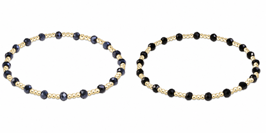 Two beaded enewton gameday serinity stretch bracelets on a plain white background. Each bracelet features alternating dark faceted beads and small metallic gold spacer beads.