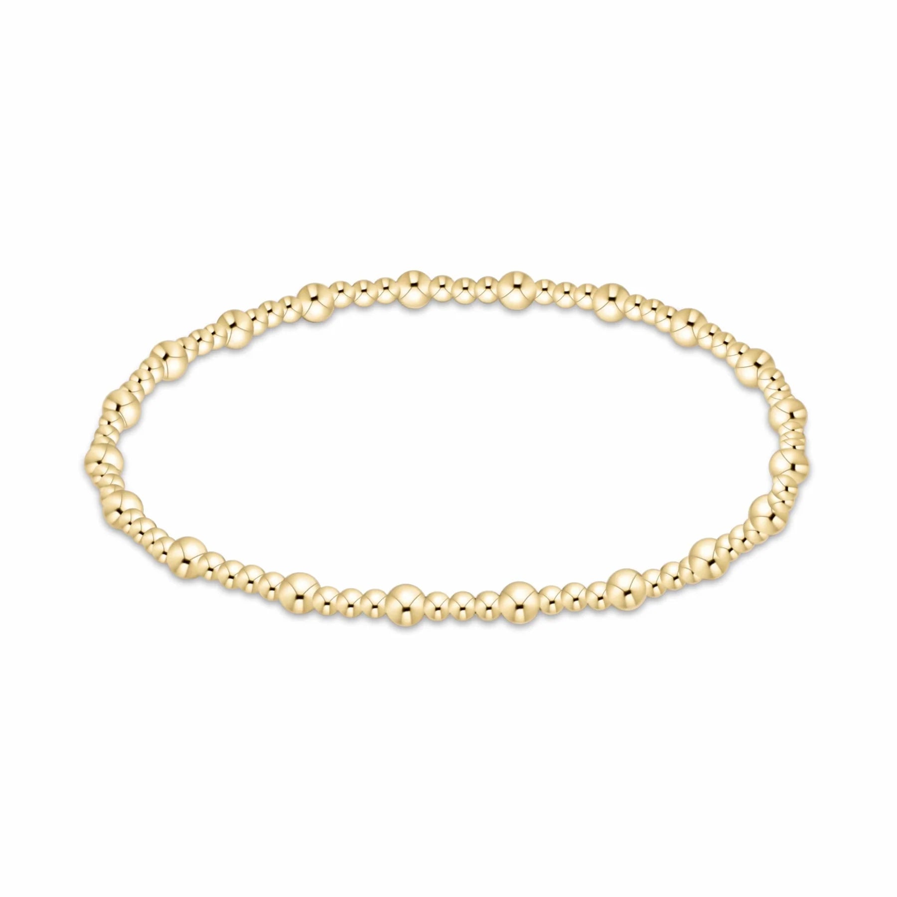 A delicate gold beaded enewton Sincerity bracelet with small, polished 3mm and 2mm spherical beads, displayed in a horizontal oval shape against a plain white background.