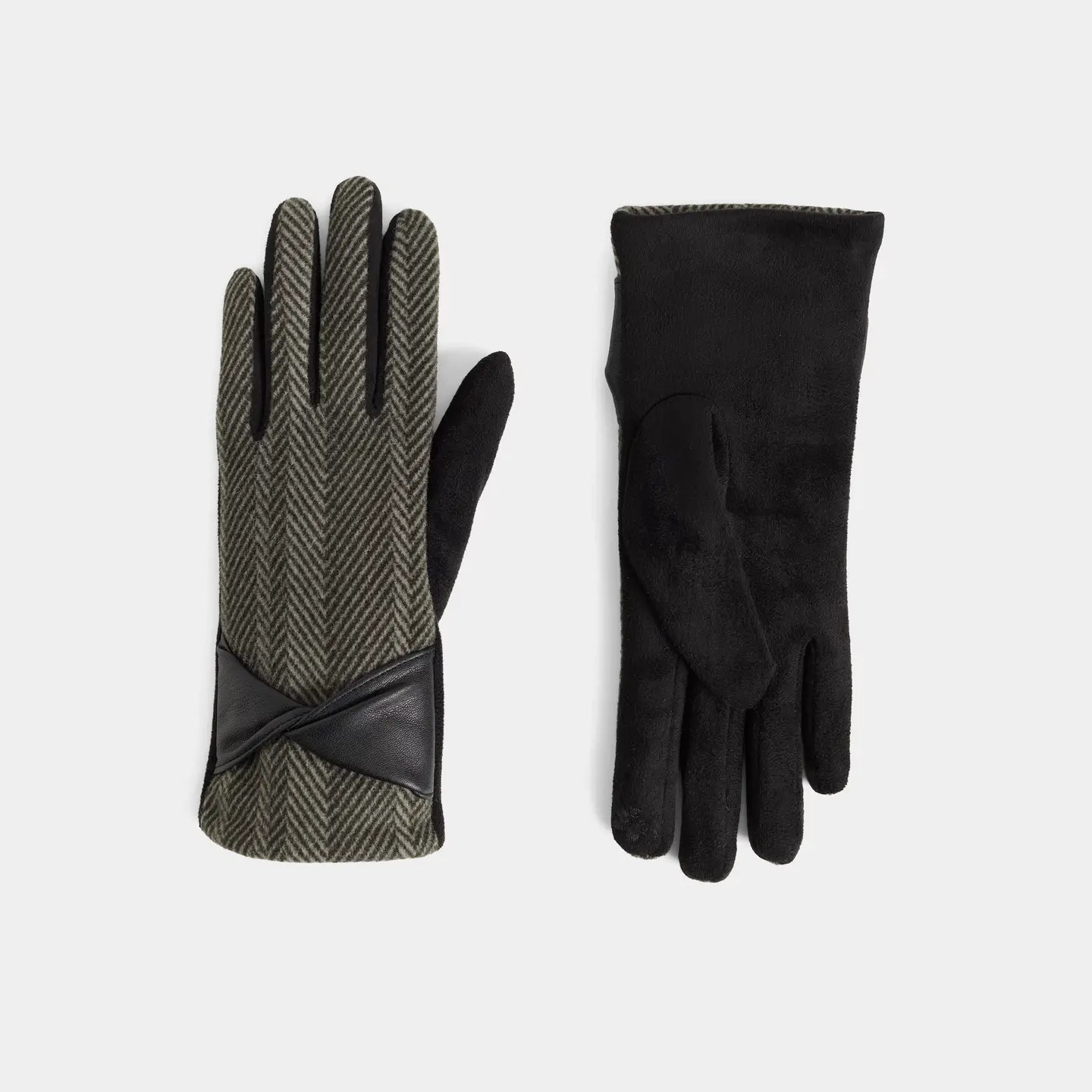 A pair of gloves shown flat against a light gray background, with one glove displaying the back in a green and black herringbone pattern with black leather trim, and the other showing the black suede-like front.
