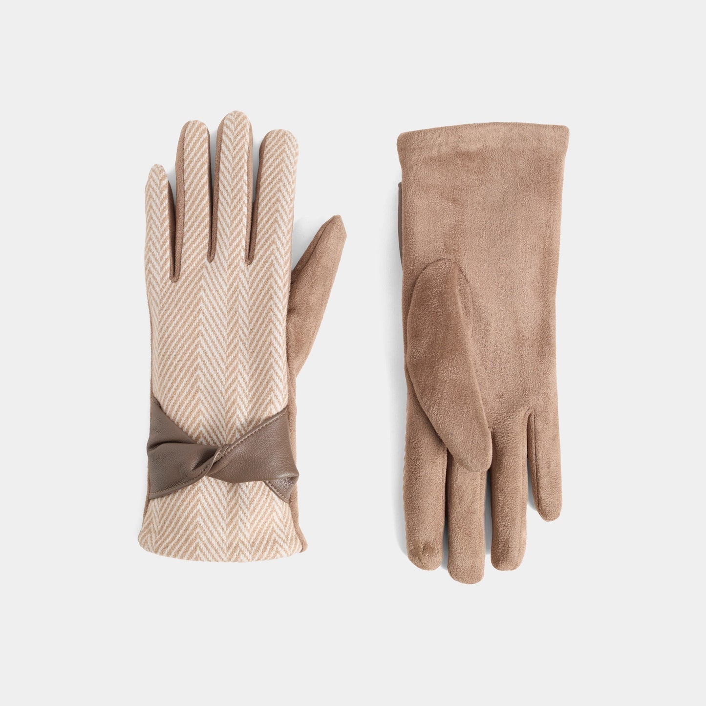 A pair of beige gloves, one showing the herringbone patterned back with a brown ribbon bow, and the other showing the smooth suede-like palm side, on a light gray background.