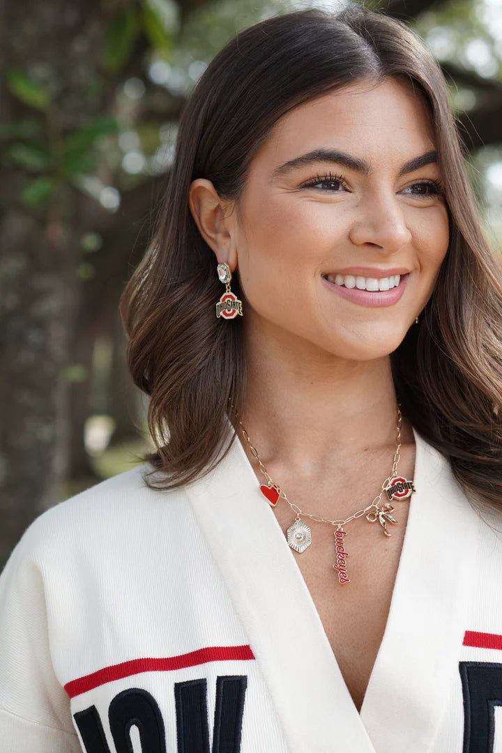 Girl wearing an Ohio State Buckeyes paper clip charm necklace with Ohio State earrings and a white sweater