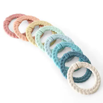 Set of pastel-colored silicone Itzy Ritzy Bitzy Bespoke Ritzy Rings Linking Ring Set - Rainbow teething rings on a white background