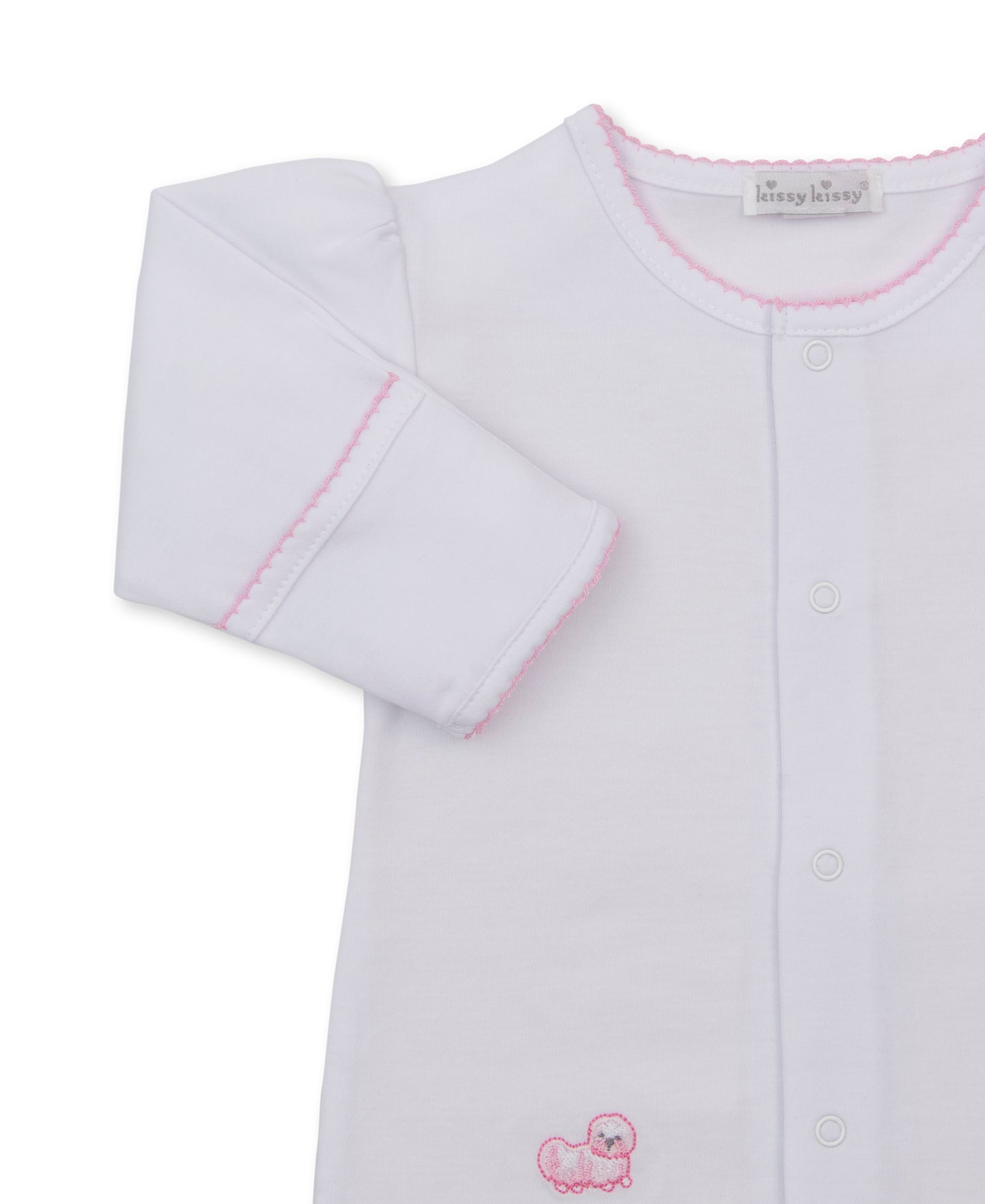 A white long-sleeve baby footie by Kissy Kissy, featuring light pink contrast stitching along the collar and cuffs, and a small pink embroidered puppy motif near the bottom left.