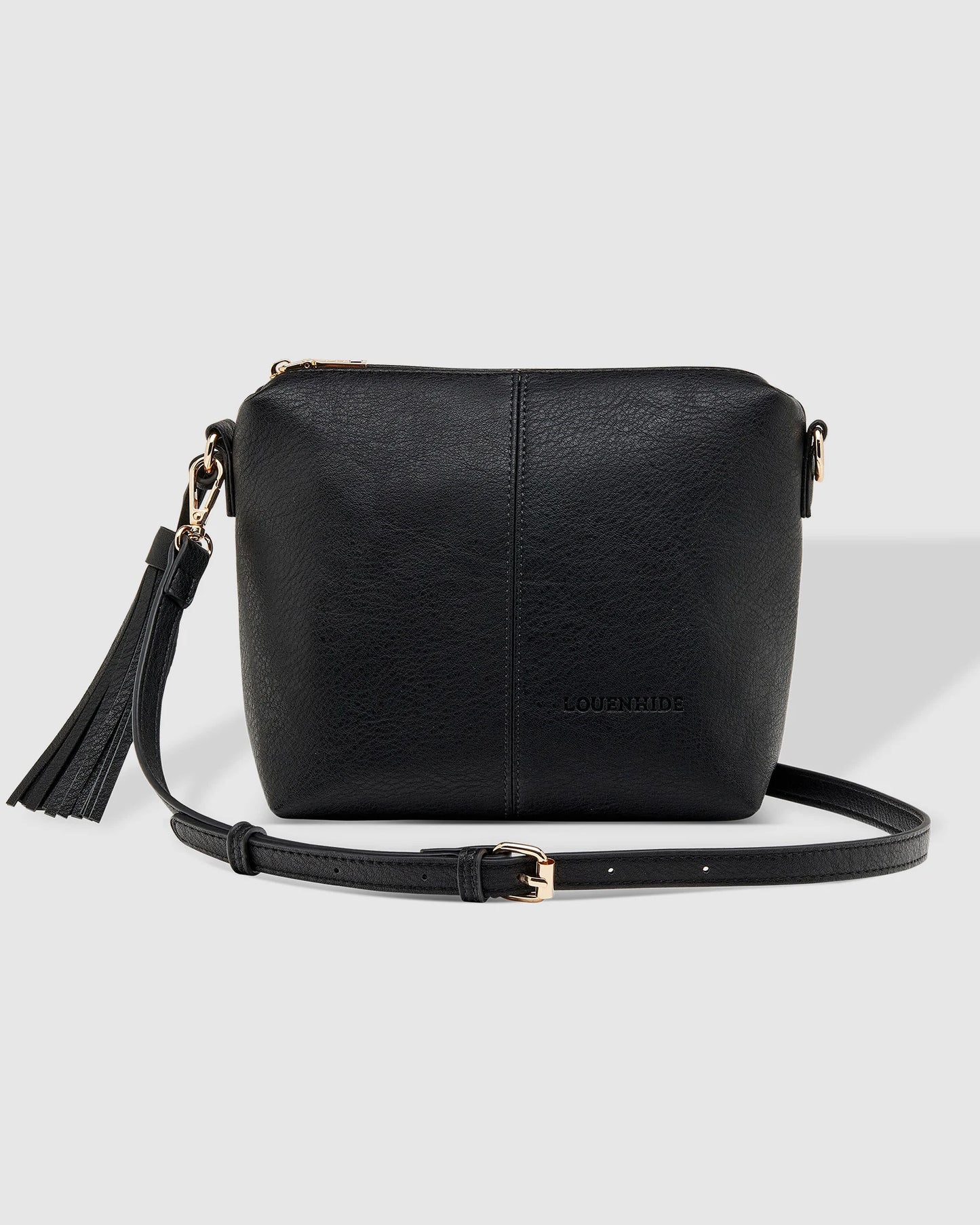 Black leather Louenhide Kasey Crossbody Bag crossbody bag with a tassel on a light gray background