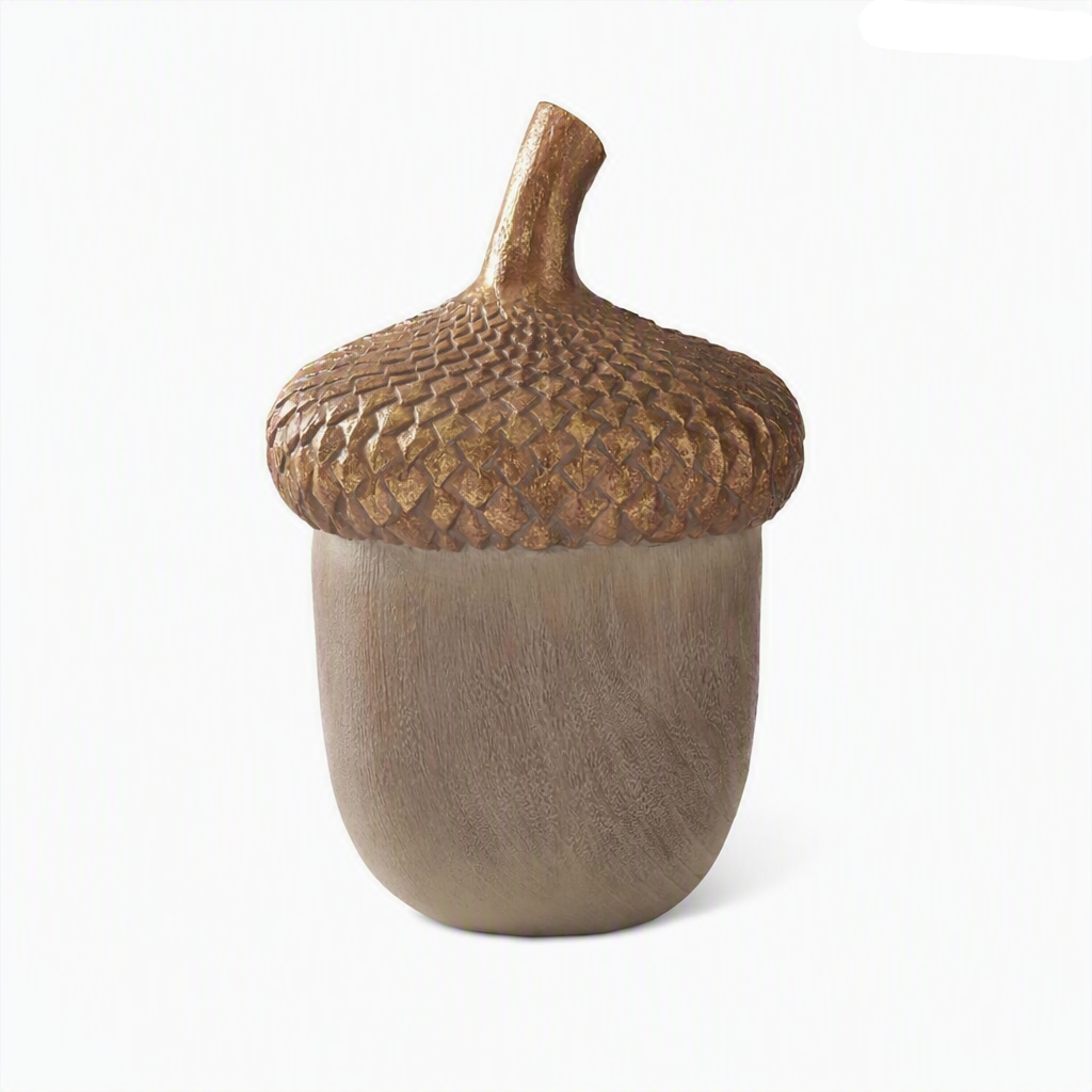 A decorative acorn sculpture with a textured, metallic gold-brown scaly cap and a smooth, matte taupe-brown body.