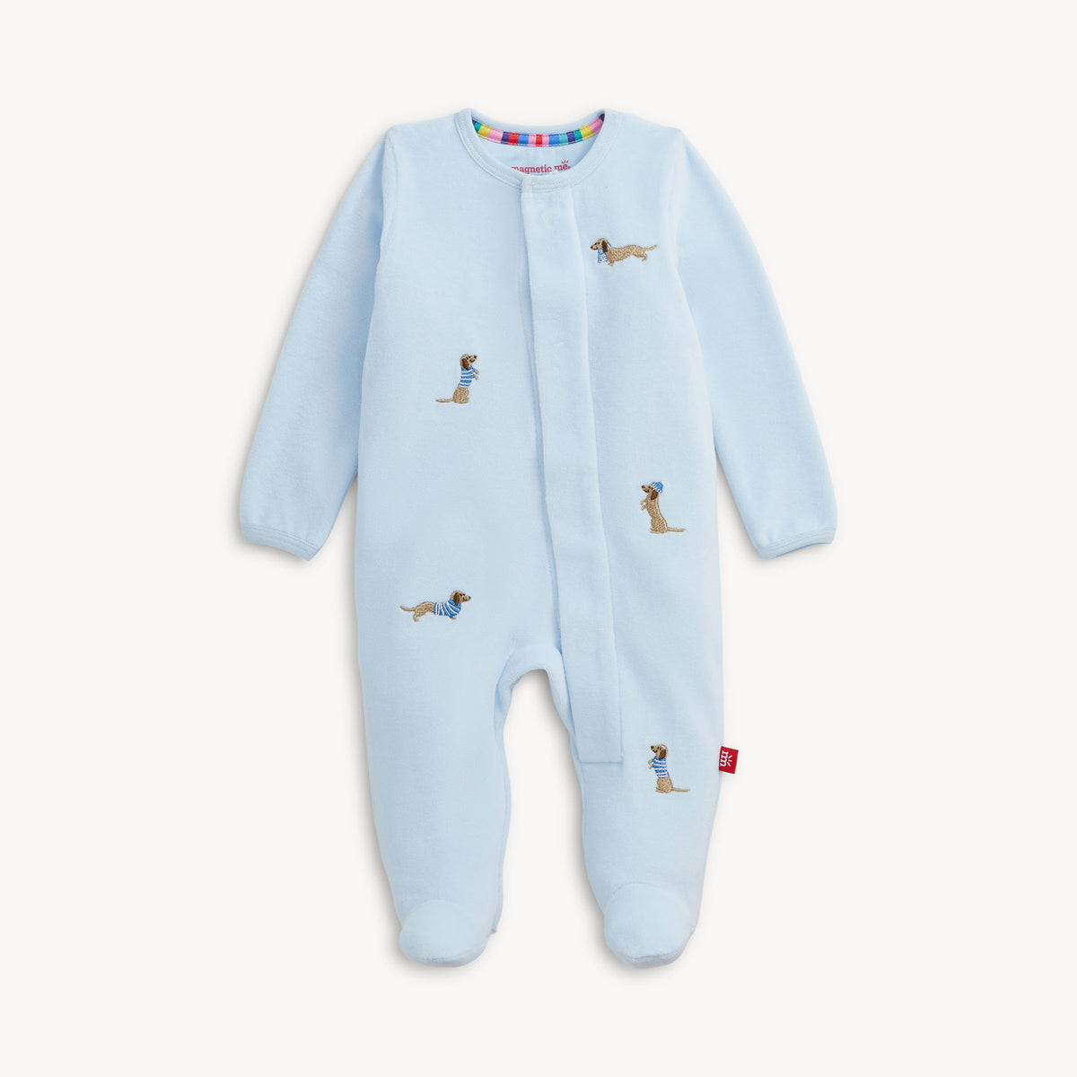 A light blue baby footed sleeper with long sleeves and an all-over print of dachshund dogs, shown on a clean off-white background.