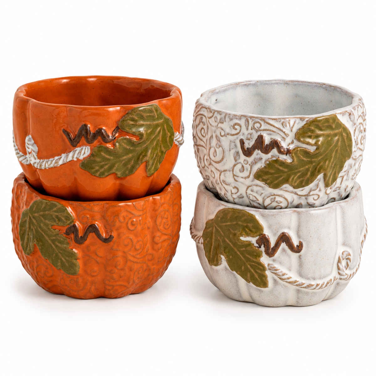 Four decorative ceramic pumpkin-shaped cups or small bowls shown in two colorways: orange and white, each with raised green leaves and brown vine details, photographed on a clean white background.