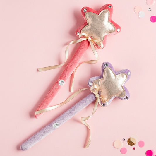 Colorful princess-themed wands in pink and purple on a pink background