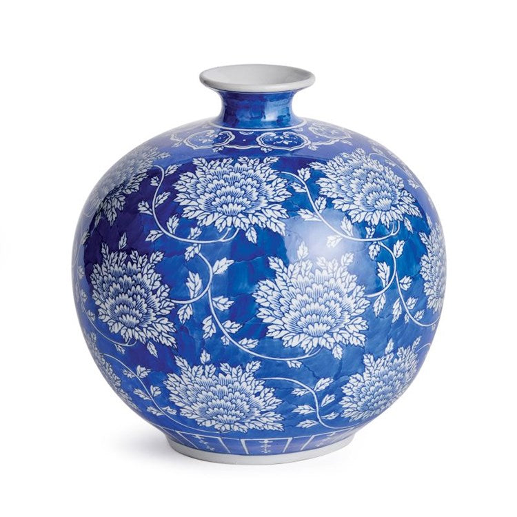 Blue ceramic vase with white floral patterns on a white background
