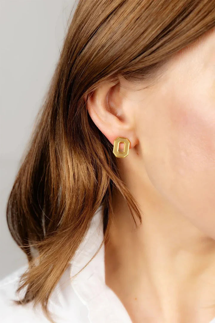 Close up of someone wearing gold plated signature O for the Ohio State Buckeyes