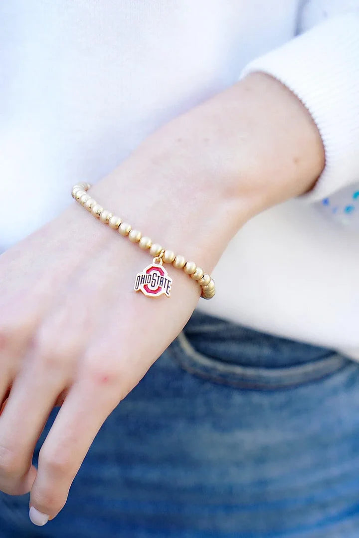 Girl wearing an Ohio State Buckeyes OSU Ball Bead Stretch Bracelet in Satin Gold