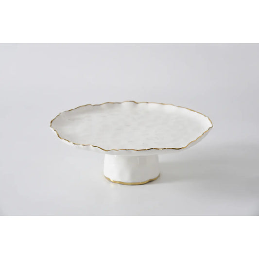 White ceramic cake stand with scalloped edge and gold trim