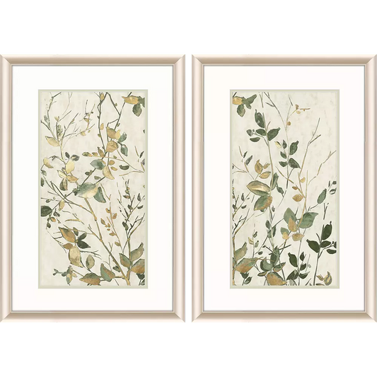 Two framed botanical prints with green and gold leaves on a beige background