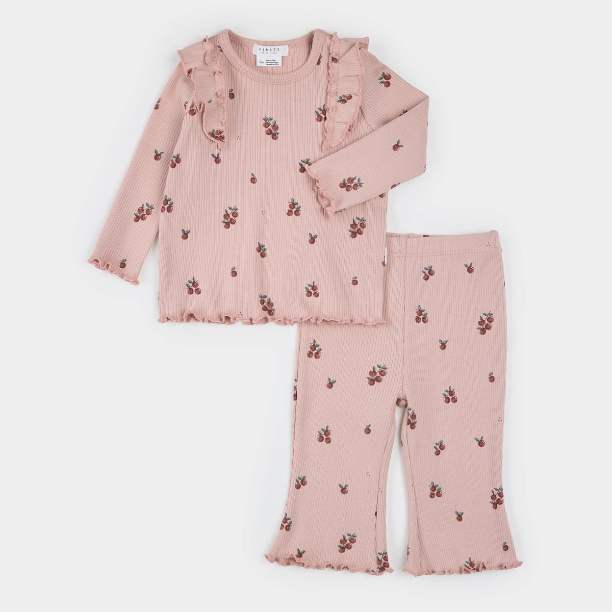 Child's two piece outfit in dusty rose with a dark red apple print. The top has ruffles on the shoulder matched with flare leg pants