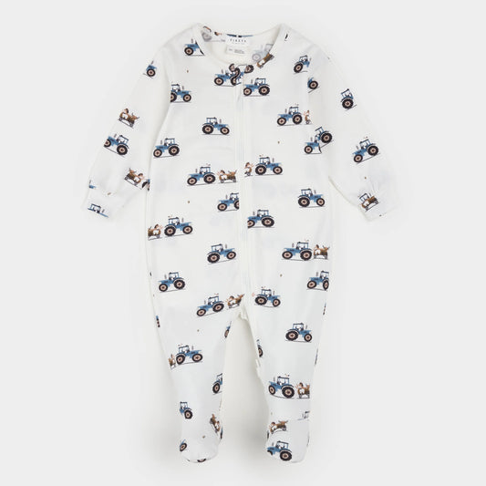 A baby footed one-piece sleeper in white, featuring an all-over print of blue tractors and small brown animals, displayed flat against a light gray background.