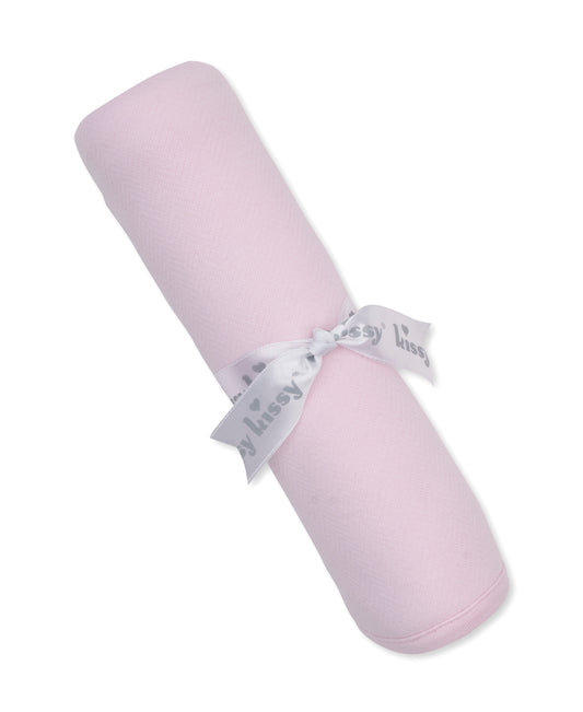 pink jacquard baby blanket rolled and tied with a kissy kissy ribbon