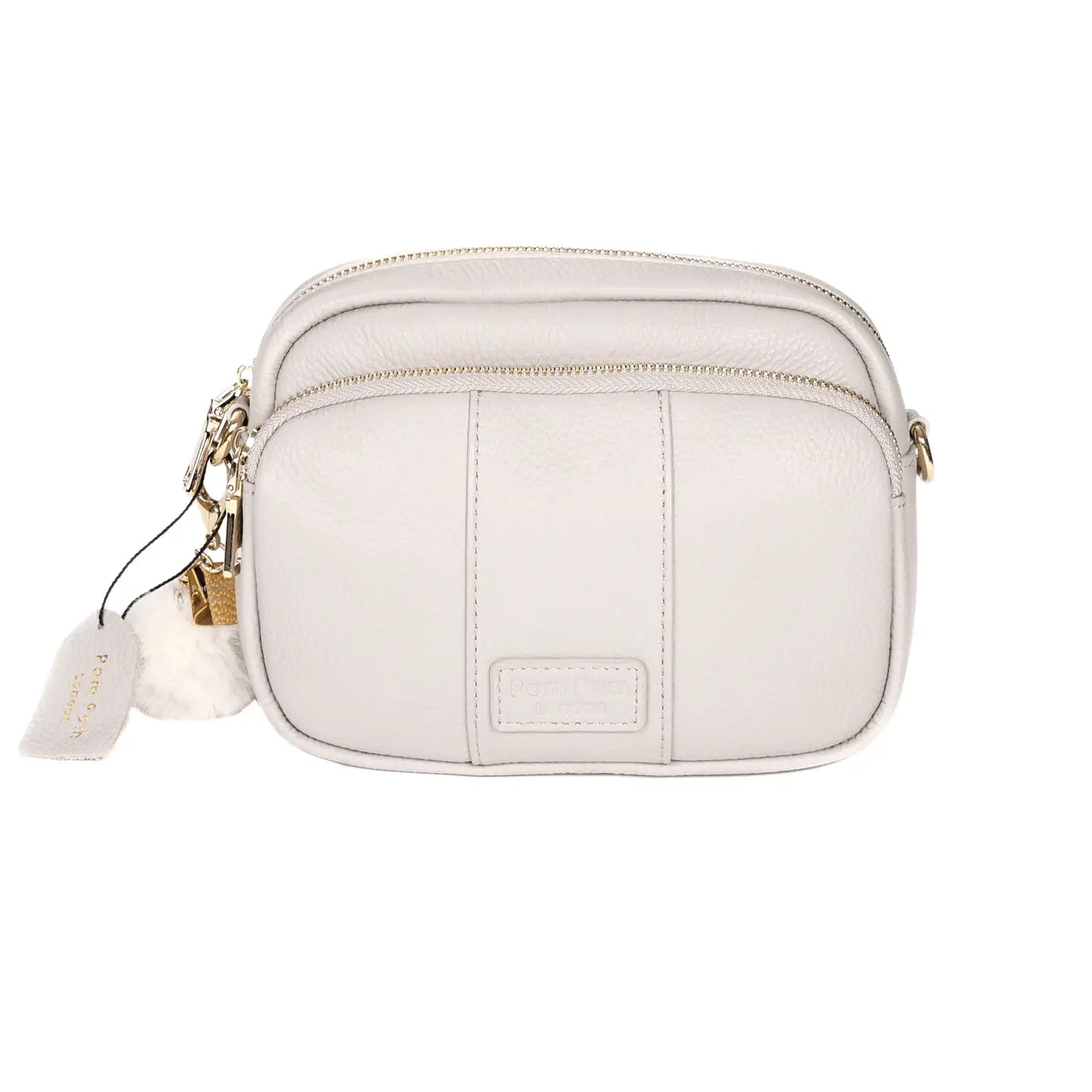 pom pom london original bag in a stone color with a pom pom tassel