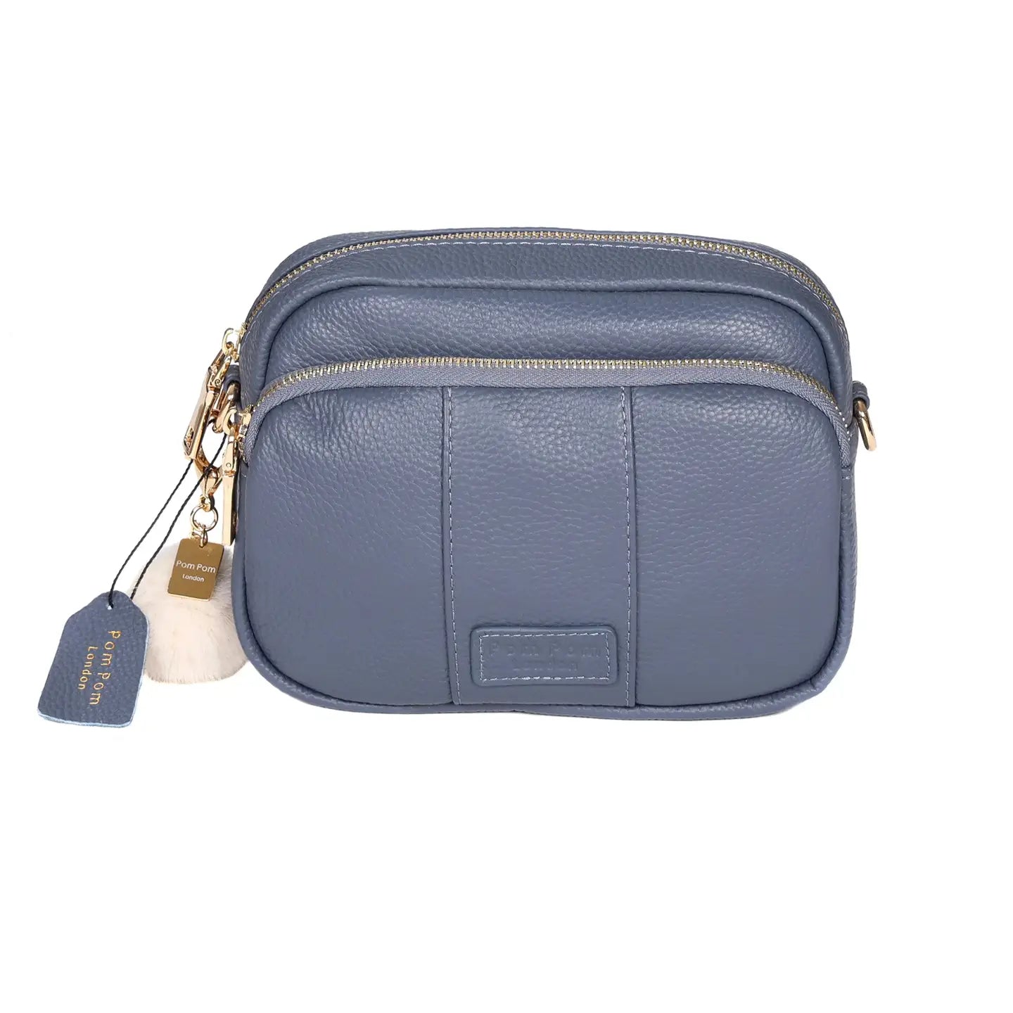 pom pom London original bag in a slate blue color with a pom tassel