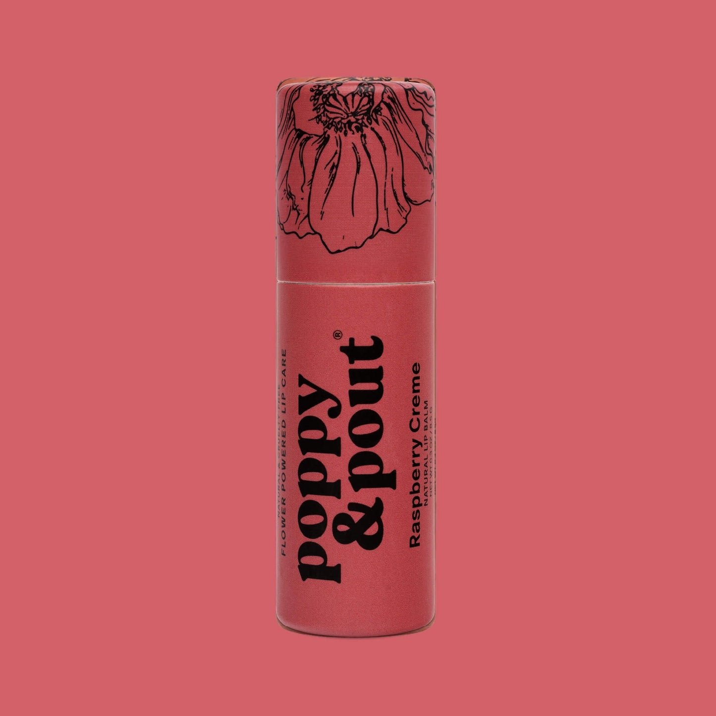 A single tube of poppy & pout Raspberry Creme lip balm standing upright against a solid pink background. The tube is a dusty rose pink with black text and a black line-art illustration of a poppy flower on the cap.