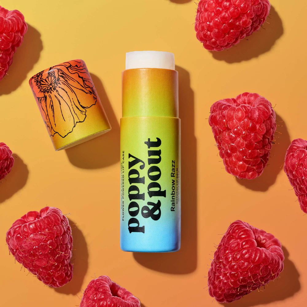 Colorful lip balm with 'Poppy & Pout' branding surrounded by raspberries on a yellow background