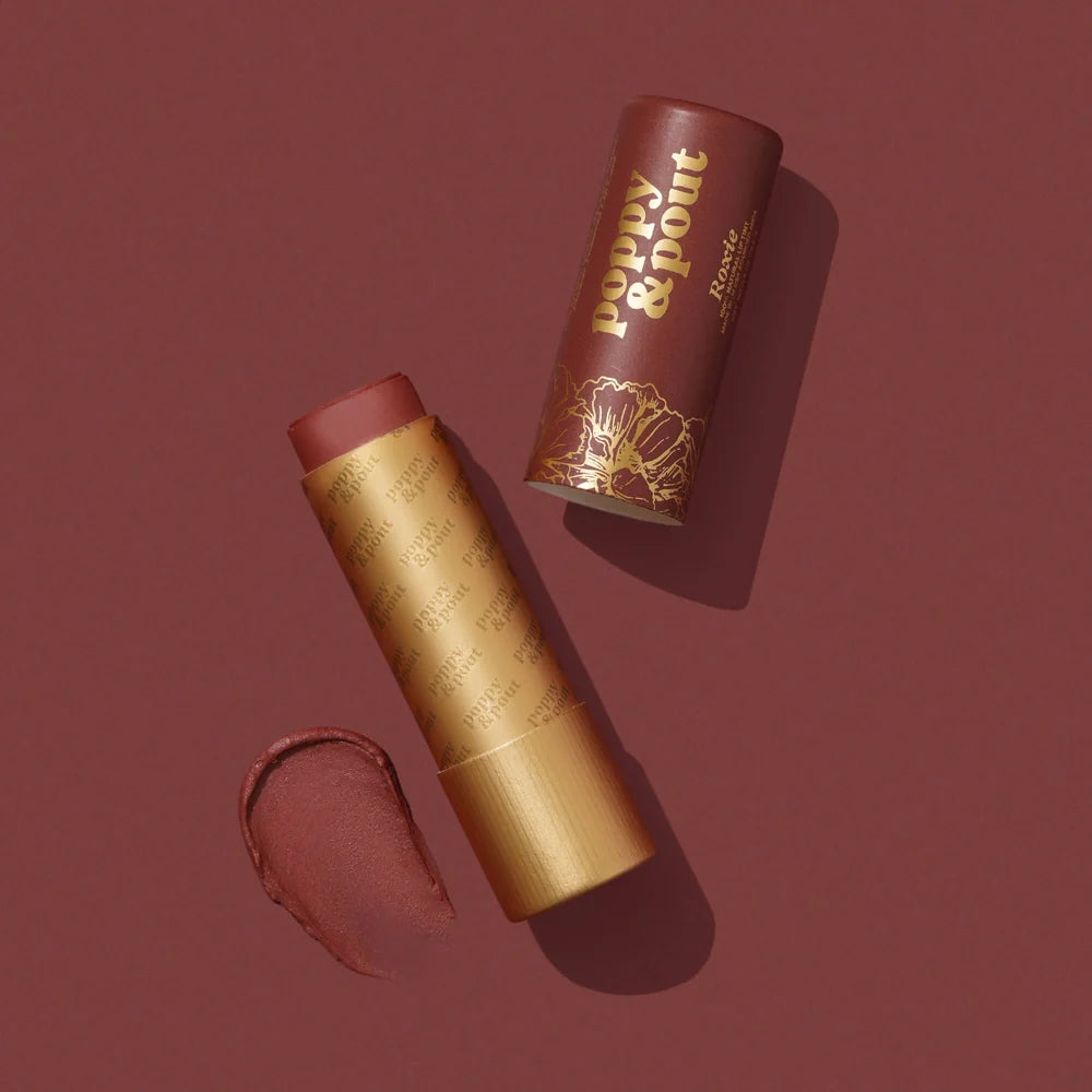 Lip tint with gold casing and brown shade on a matching background, featuring the brand 'Poppy & Point'.