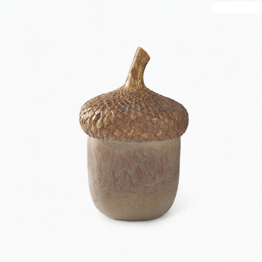 A decorative acorn-shaped sculpture with a textured metallic gold cap and a matte brown body.