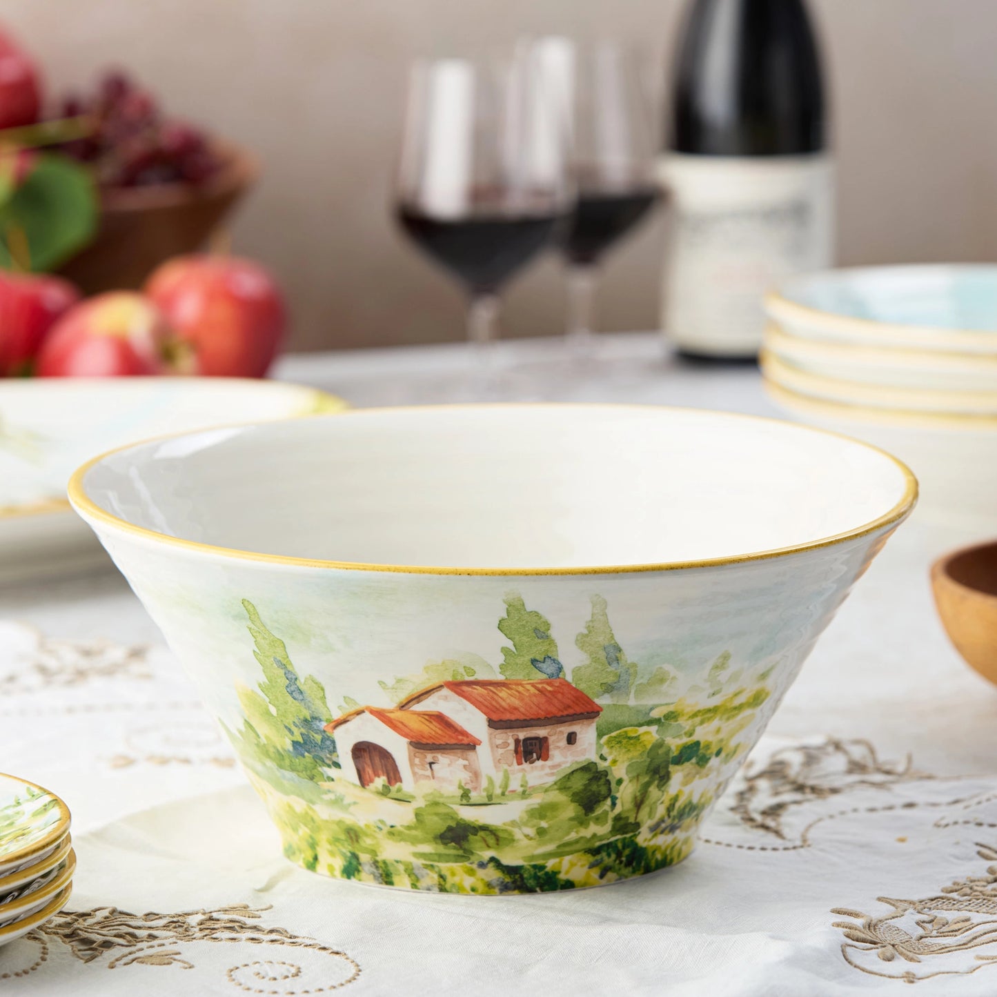 Decorative deep ceramic bowl with a Tuscan landscape design.