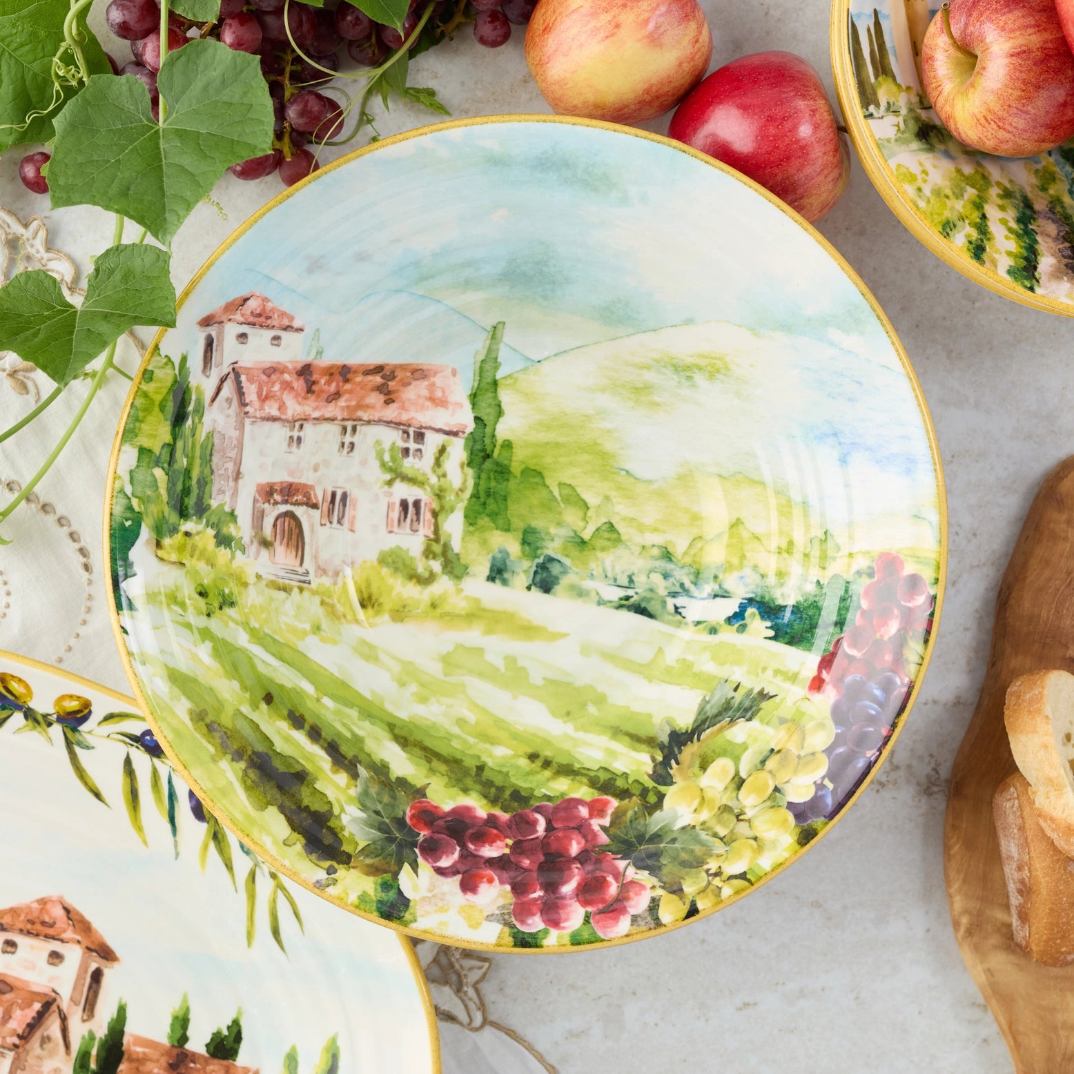 Inside view of a Tuscany pasta bowl with an image of a hand painted villa with grapes.