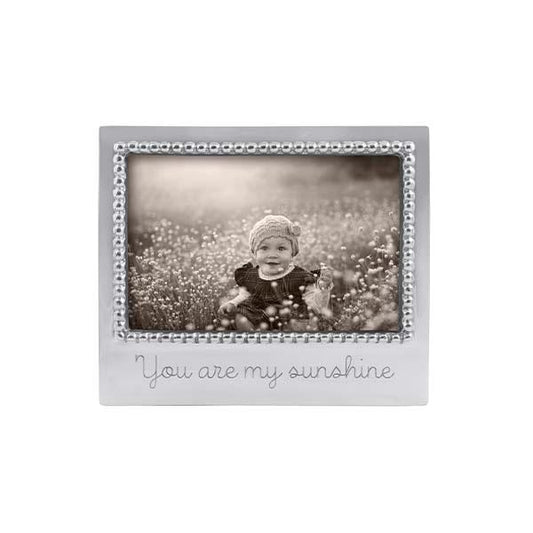 A beaded silver photo frame with the inscription 'You are my sunshine' on the bottom.