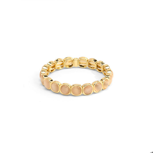 A gold-plated stretch bracelet featuring oval pale peach-beige stones.